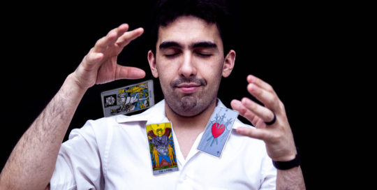 Man with cards flying around him