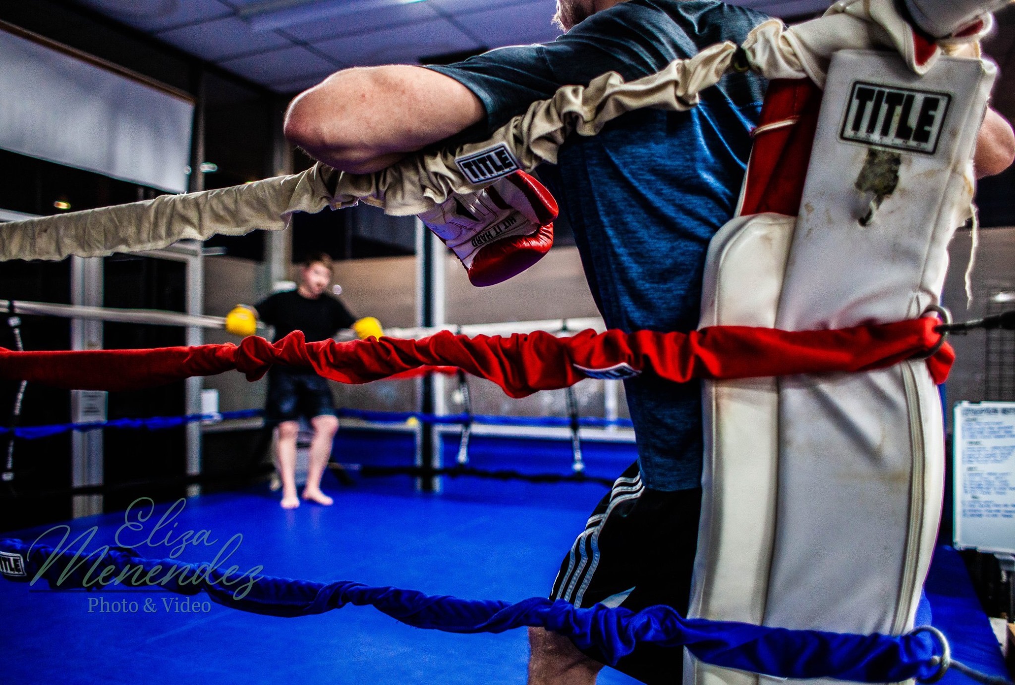 Two boxers taking a break before going back at it in the ring.