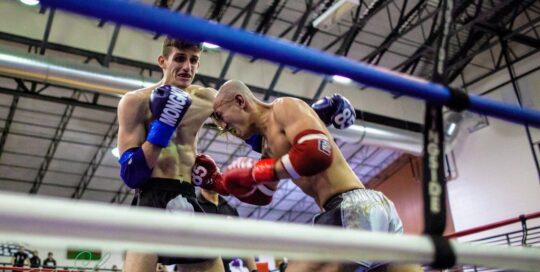 Jadin getting punched in the stomach by his opponent