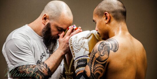 Jordon praying with coach before the fight